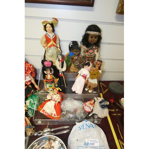 4157 - A collection of miscellaneous souvenir dolls, vintage jigsaws, stamps and other trinkets
