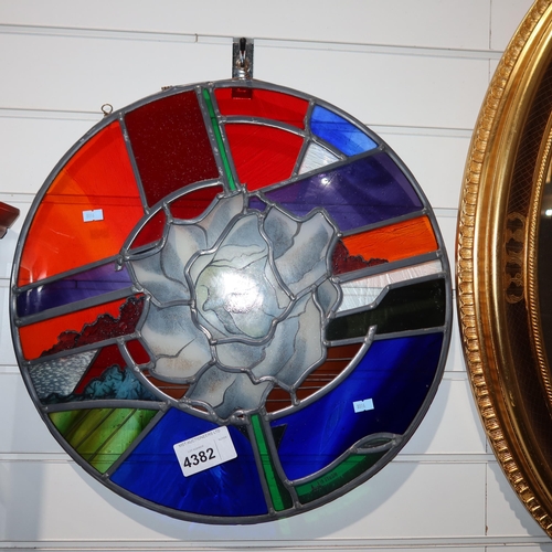 Circular stained glass panel of a rose