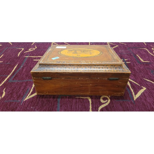 4227 - An inlaid decorative writing box with a lift lid enclosing writing slope and fitted interior