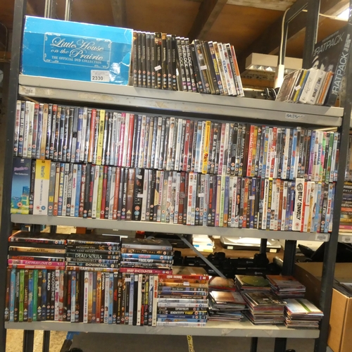 2330 - A large quantity of various DVDs and CDs, contents of 3 shelves