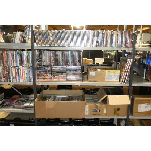 2332 - A large quantity of various DVDs and CDs, many still sealed , contents of 3 shelves