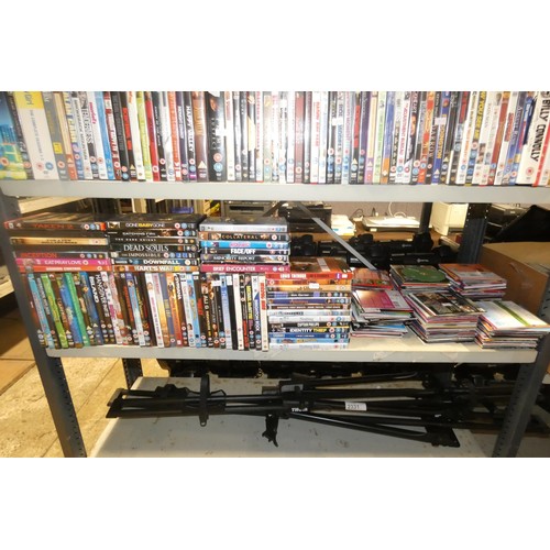 2330 - A large quantity of various DVDs and CDs, contents of 3 shelves