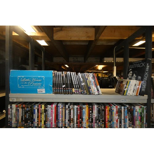 2330 - A large quantity of various DVDs and CDs, contents of 3 shelves