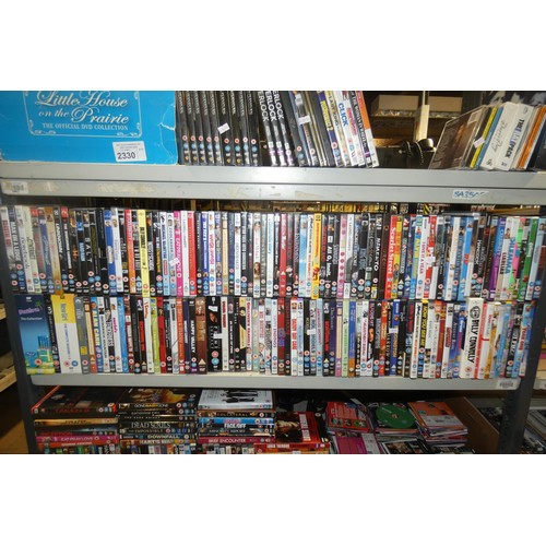 2330 - A large quantity of various DVDs and CDs, contents of 3 shelves