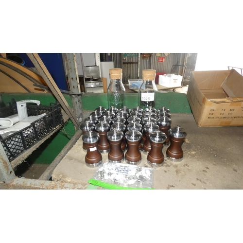 1025 - A quantity of salt and pepper mills and 2 glass containers