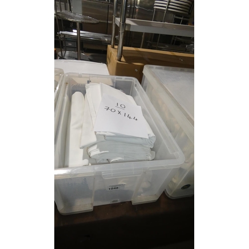 1048 - A quantity of 10 white table cloths approx 70x144, contents of 1 plastic crate