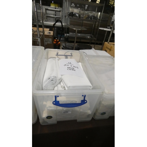 1050 - A quantity of 12 white table cloths approx 70x144, contents of 1 plastic crate