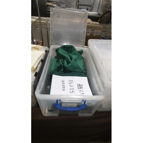 1053 - A quantity of 29 green table cloths approx 35x35, contents of 1 plastic crate