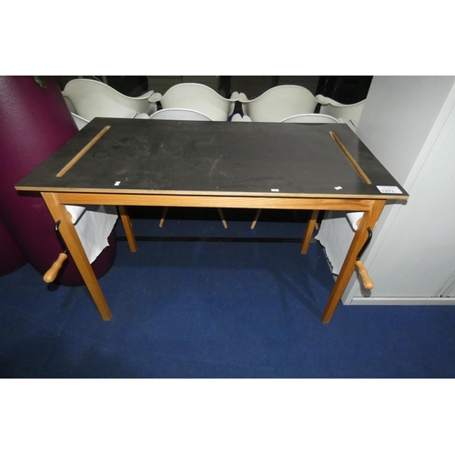 1273 - A table with a hand operated paper dispensing roll / slot on each end, table approx 115 x 60cm (for ... 