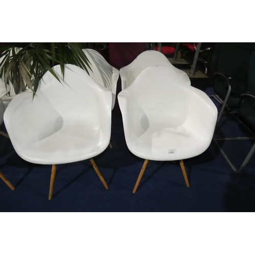 1287 - 4 x white plastic designer style chairs with wood / black metal legs