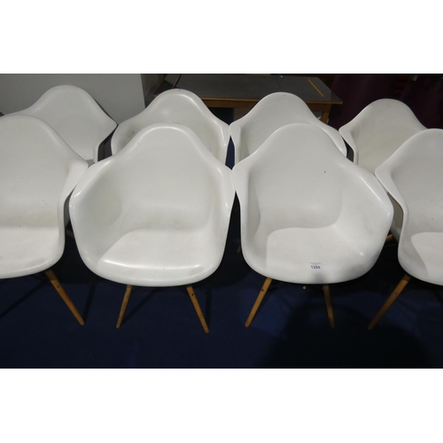 1289 - 4 x white plastic designer style chairs with wood / black metal legs