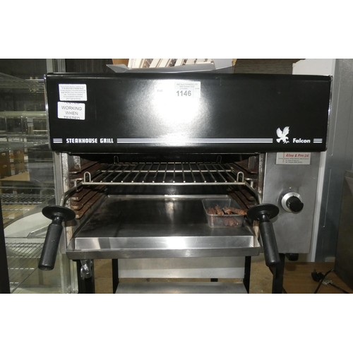 1146 - A gas fired steakhouse grill by Falcon, comes on a stand with 2 shelves below, some stones require r... 