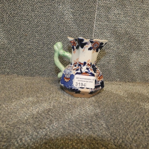 3194 - A small Masons ironstone china oriental decorated jug with light green handle