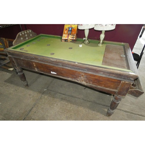 A vintage wooden bar billiards table