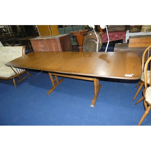 A large golden Ercol extending dining table with 3 centre leaves approx