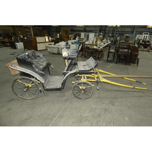 A vintage pony carriage/trap with 4 wheels, complete with mounted coach