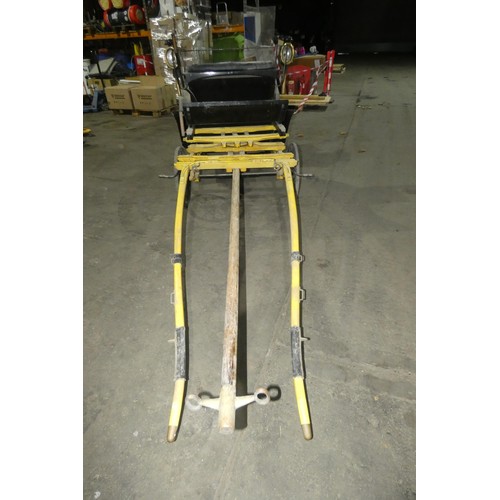 A vintage pony carriage/trap with 4 wheels, complete with mounted coach