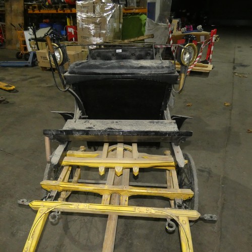 A vintage pony carriage/trap with 4 wheels, complete with mounted coach