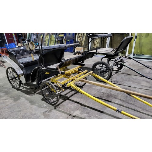 A vintage pony carriage/trap with 4 wheels, complete with mounted coach