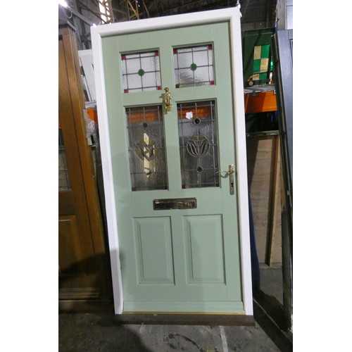 10 - An engineered hardwood triple glazed external door in frame, colour is green door / white frame both... 