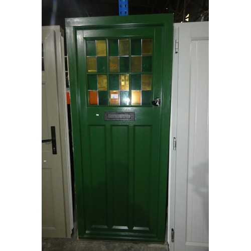 28 - An Evolution PVC  external door with decorative glass in frame, colour is dark green on both sides, ... 