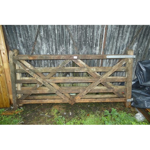 723 - A pair of wooden gates with some ironmongery attached, each measuring approx 8ft / 244cm