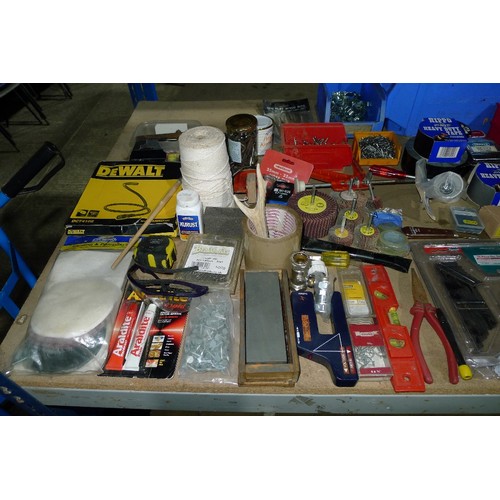 484 - A large quantity of various tools and other items including whet stones, rolls of tape, 2 axes, flap... 