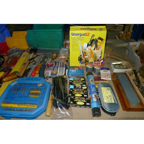 484 - A large quantity of various tools and other items including whet stones, rolls of tape, 2 axes, flap... 