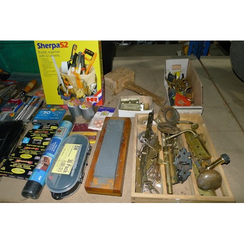 484 - A large quantity of various tools and other items including whet stones, rolls of tape, 2 axes, flap... 