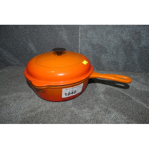 1040 - An orange Le Cruset cast iron sauce pan with lid