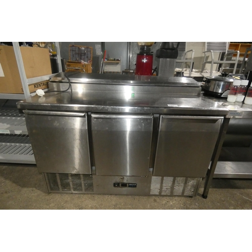 1267 - A commercial stainless steel 3 door bench fridge with salad/pizza prep bar by Blizzard (on button re... 