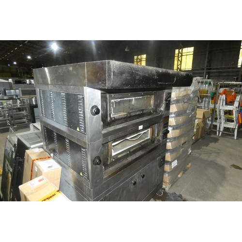 1025 - A large commercial stainless steel pizza oven by Moretti Forni with 2 ovens on a 2 door heated cabin... 