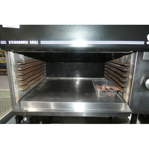 1283 - A gas fired steakhouse grill by Falcon, comes on a stand with 2 shelves below, some stones require r... 