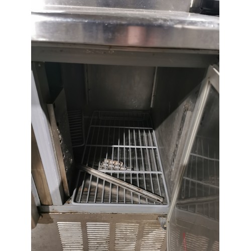 1267 - A commercial stainless steel 3 door bench fridge with salad/pizza prep bar by Blizzard (on button re... 