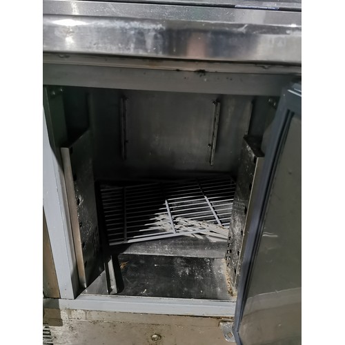 1267 - A commercial stainless steel 3 door bench fridge with salad/pizza prep bar by Blizzard (on button re... 