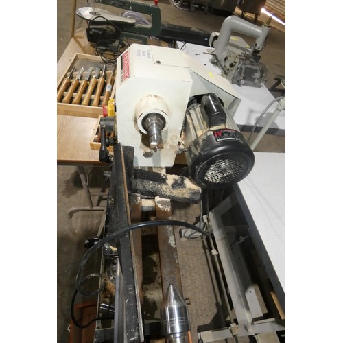 2061 - An Axminster wood turning lathe on stand type AWVSL 1000, 240v supplied with a selection of various ... 