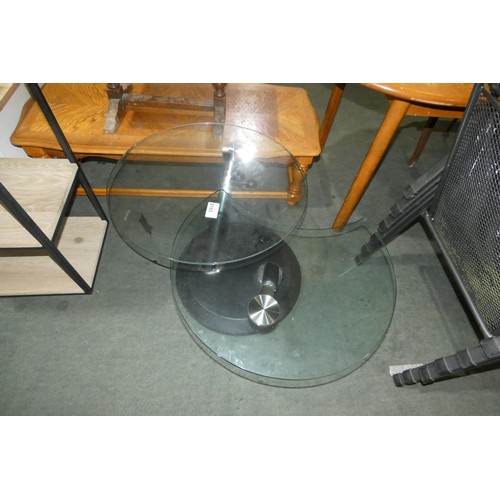 2183 - A Modesto metal and glass swivel cocktail table. Please note that one of the black leg trims require... 