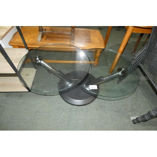 2183 - A Modesto metal and glass swivel cocktail table. Please note that one of the black leg trims require... 