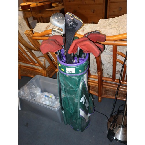 2190 - A Yonex golf club bag containing 16 various golf clubs and 1 box containing a quantity of golf balls