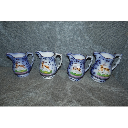 2782 - A set of four blue, white and pictorial graduated hunting jugs