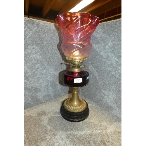 2805 - A Victorian brass oil lamp with a ruby glass Reservoir and a ruby glass shade