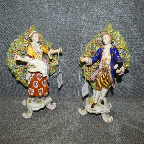 2807 - A pair of Chelsea style porcelain figures of a boy and girl with flowers approximately 28 cm tall