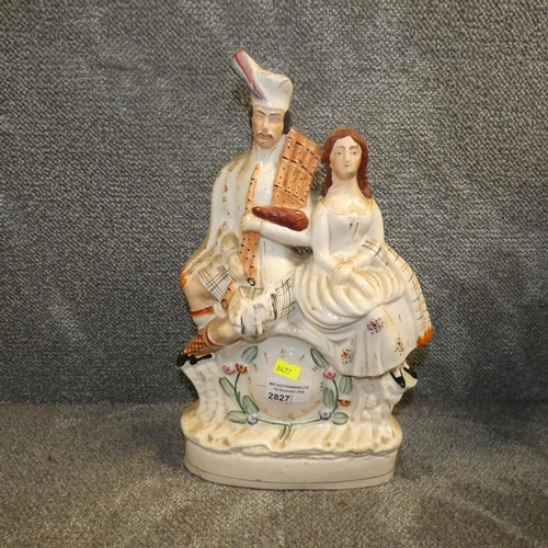 2827 - A staffordshire flatback figure of a Highlander and girl