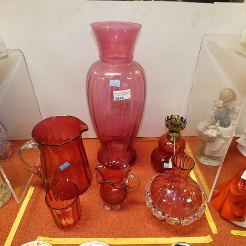 2844 - A tall cranberry glass vase and 5 other pieces of decorative cranberry glassware