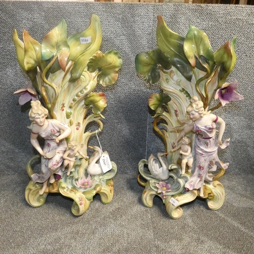 2847 - A pair of very ornate floral encrusted continental figures with swans, approximately 45 cm tall