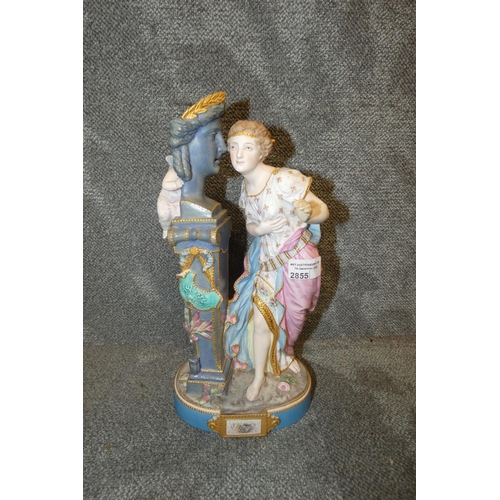 2855 - A decorative continental porcelain figure of a Lady being whispered to by a winged cherub, approxima... 