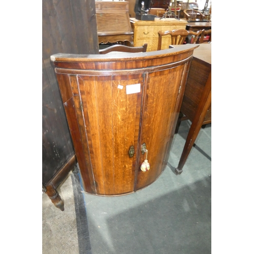 3019 - An early 19th century oak barrel fronted wall hanging cabinet with two doors, approximately 100cm hi... 