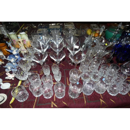 2882 - A vintage blue glass soda syphon, various glass decanters, various decorative glass jugs and vases a... 