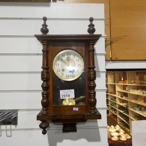 2919 - A small mahogany case wall clock with a glass door