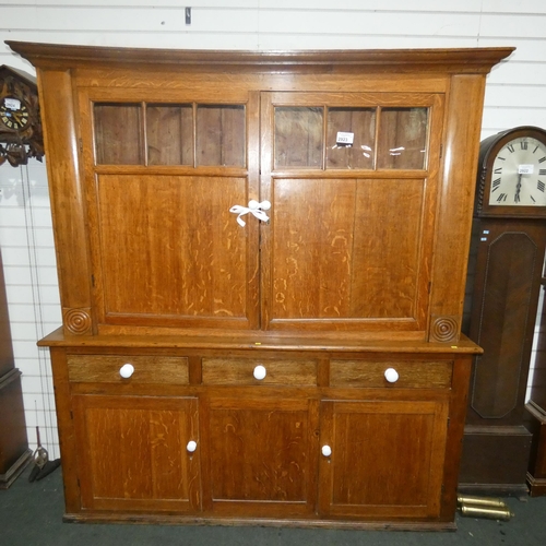 2923 - A large vintage Oak kitchen cabinet / dresser with 2 panelled and glazed doors enclosing shelves, 3 ... 